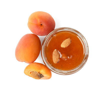 Apricot jam in jar with fresh fruit, isolated on white