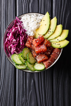 Raw Organic Ahi Tuna Poke Bowl with Rice and Veggies close-up. Vertical top view