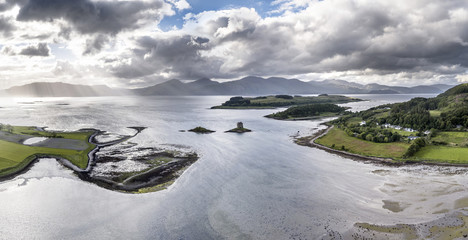 Aerial view of Loch Laich with the historic castle Stalker in the background in Argyll