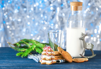 Tasty Christmas homemade cookies and bottle with milk on table