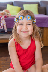 portrait of little girl smiling with red shirt and diadem