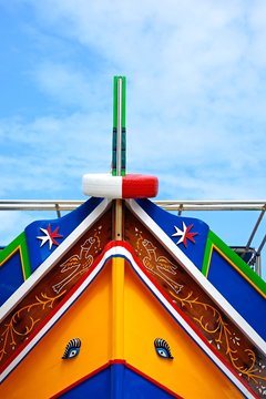 The bow of a brightly painted traditional Dghajsa boat, Bigibba, Malta.