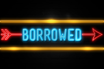 Obraz premium Borrowed - fluorescent Neon Sign on brickwall Front view