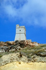 Fototapeta na wymiar View of Ghajn Tuffieha watchtower which overlooks the coastline, Ghajn Tuhheiha Bay, Malta.