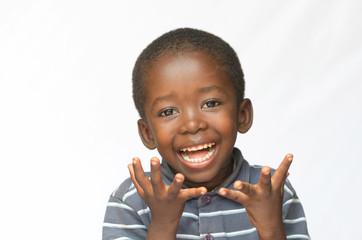 Surprised little African boy excited about getting a present isolated on white