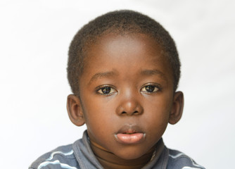 Close-up of African boy being a little sad, angry and full of despair