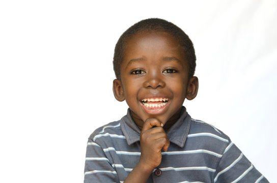 Portrait of African black boy child smiling with toothy smile isolated on white