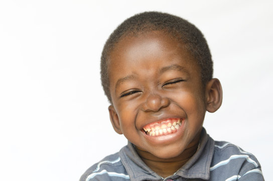 Awesome huge smile on black African ethnicity black boy child isolated on white Portrait
