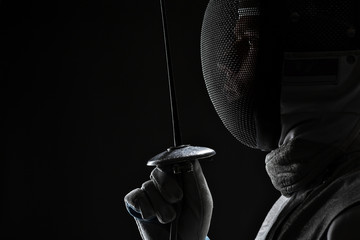 Male fencer with Mask holding the sword in front of his - obrazy, fototapety, plakaty