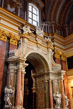 Elaborate archway surrounded by statues of angels inside St Pauls Cathedral also known as Mdina Cathedral, Mdina, Malta.