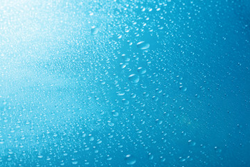 Naklejka na ściany i meble drops of water close-up on a blue background