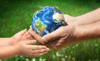 The man gives planet Earth to baby. Ecology concept. Elements of this image furnished by NASA