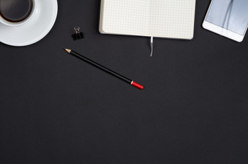Business objects on a black desk.