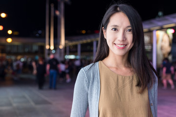 Fototapeta premium Woman smile to camera in the city at night