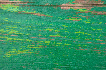 Texture of old boards long covered with peeling green paint