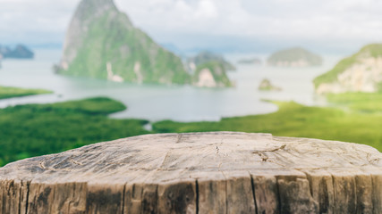Old empty wood table on top of mountain view island and beach abstract background.