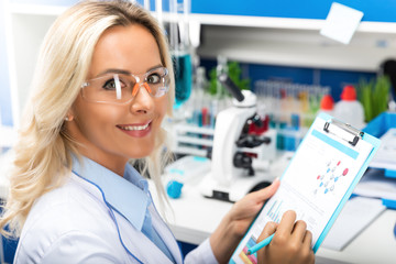 Young attractive woman scientist researching in the laboratory