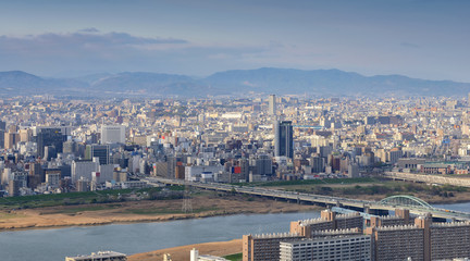 High angle panoramic view of Osaka city with Yodo river at sunset time. Japan