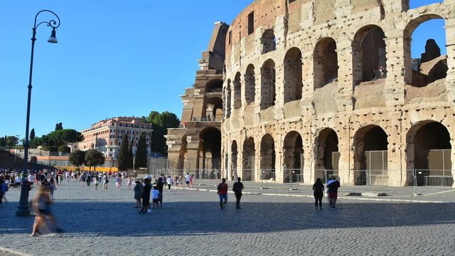 Time Lapse: The beautiful Colosseum in Rome with many tourists visiting.