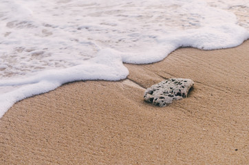 Close up tropical beach with smooth wave and sand texture background.