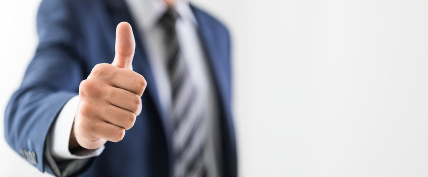 Business man shows thumb up sign gesture.