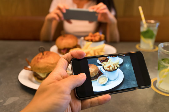 Taking photo on cellphone in restaurant