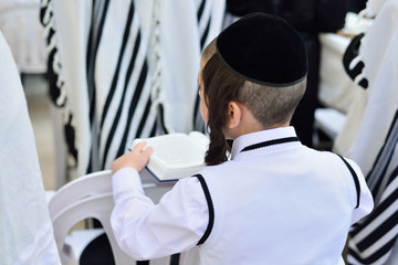 JERUSALEM, ISRAEL - APRIL 2017: Jewish hasidic pray a the Western Wall, Wailing Wall the Place of Weeping is an ancient limestone wall in the Old City of Jerusalem.