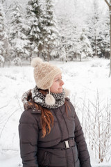 Young beautiful woman walking in a park forest in cold  winter air. Christmas girl. Good weather outdoors