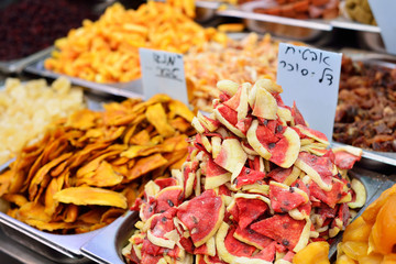 Dried fruit in the market, dried mango and watermelon. On the plate is written 