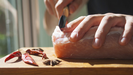 A man cuts meat. Pork, chops. cooking