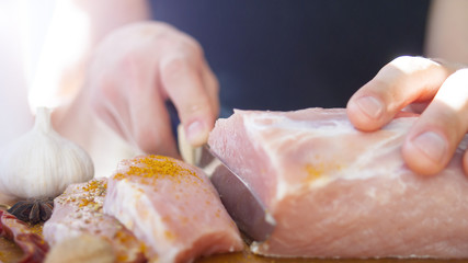 A man cuts meat. Pork, chops. cooking