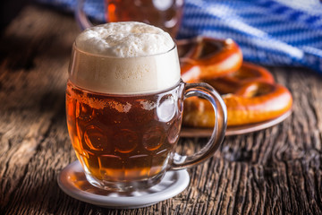 Beer and Oktoberfest. Draft beer pretzel and blue checkered tablecloth as traditional products for...