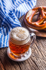 Beer and Oktoberfest. Draft beer pretzel and blue checkered tablecloth as traditional products for bavarian festival oktoberfest