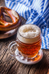 Beer and Oktoberfest. Draft beer pretzel and blue checkered tablecloth as traditional products for bavarian festival oktoberfest