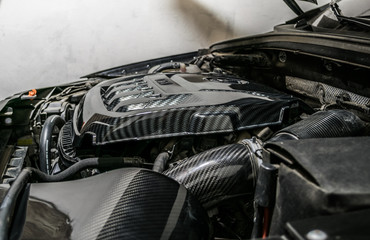 Close up detail of car engine, carbon fiber part