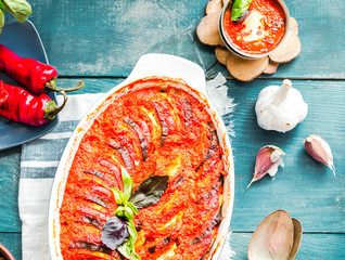 ratatouille in baking dish on a blue rustic background, top view.traditional French Provencal...