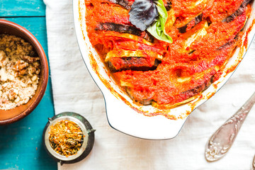 ratatouille in baking dish on a blue rustic background, top view.traditional French Provencal...