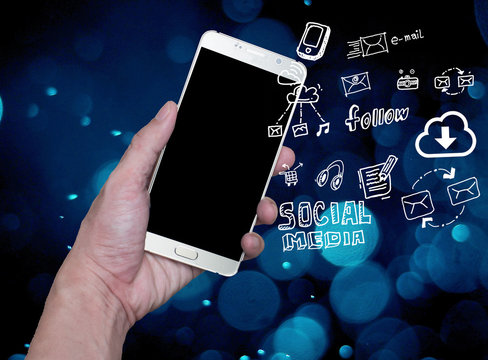 hand holding mobile phone with cloud computing with blue background .Hand holding smartphone with hand drawn media icons and symbols concept style. - Powered by Adobe