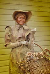 girl sculpture with basket of flowers