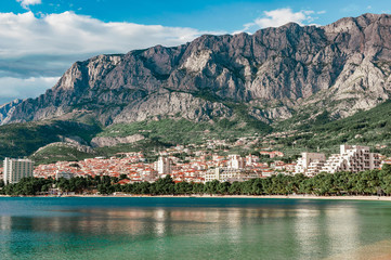 Coast, sea and beach below the mountain Biokovo in the town of Makarska in Croatia