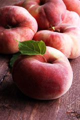Ripe peaches in basket on wooden background