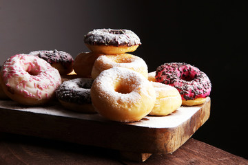 assorted donuts with chocolate frosted, pink glazed and sprinkles donuts.