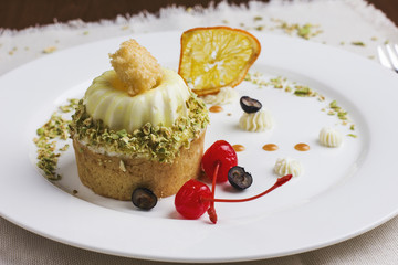 Dessert with a mousse-cream, with cherries, grapes and dried orange