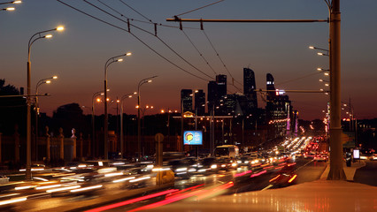 View of the street Crimean shaft and the business center of Moscow city with a busy traffic on the street in the evening..