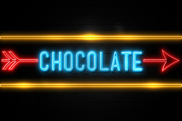 Obraz premium Chocolate - fluorescent Neon Sign on brickwall Front view