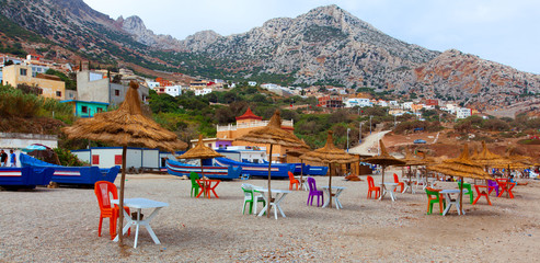 Panorama of Beautiful coastline in morocco. belyouneche. Chairs And Umbrella In moroccan Beach. colorful chairs under umbrella at beach