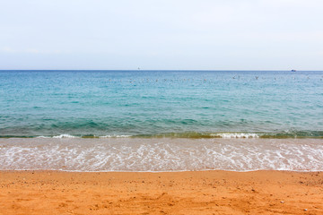 Fototapeta na wymiar Soft wave of blue ocean on sandy beach. Tropical beach in Moroccan sea. belyouneche