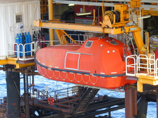 Life boat or survival craft at muster station of oil and gas drilling rig