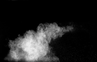 Launched white powder isolated on black background.