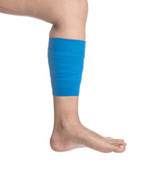 Leg wrapped in elastic bandage on white background,Leg pain